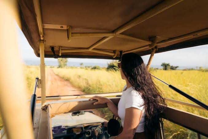 Solo female traveller on a game drive in Murchison falls